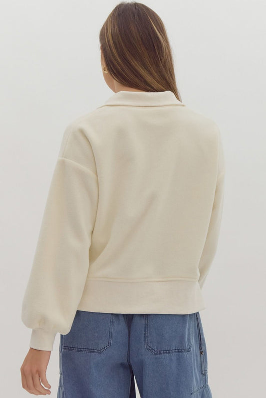 +Solid long sleeve collared crop sweater featuring quarter zip detail.