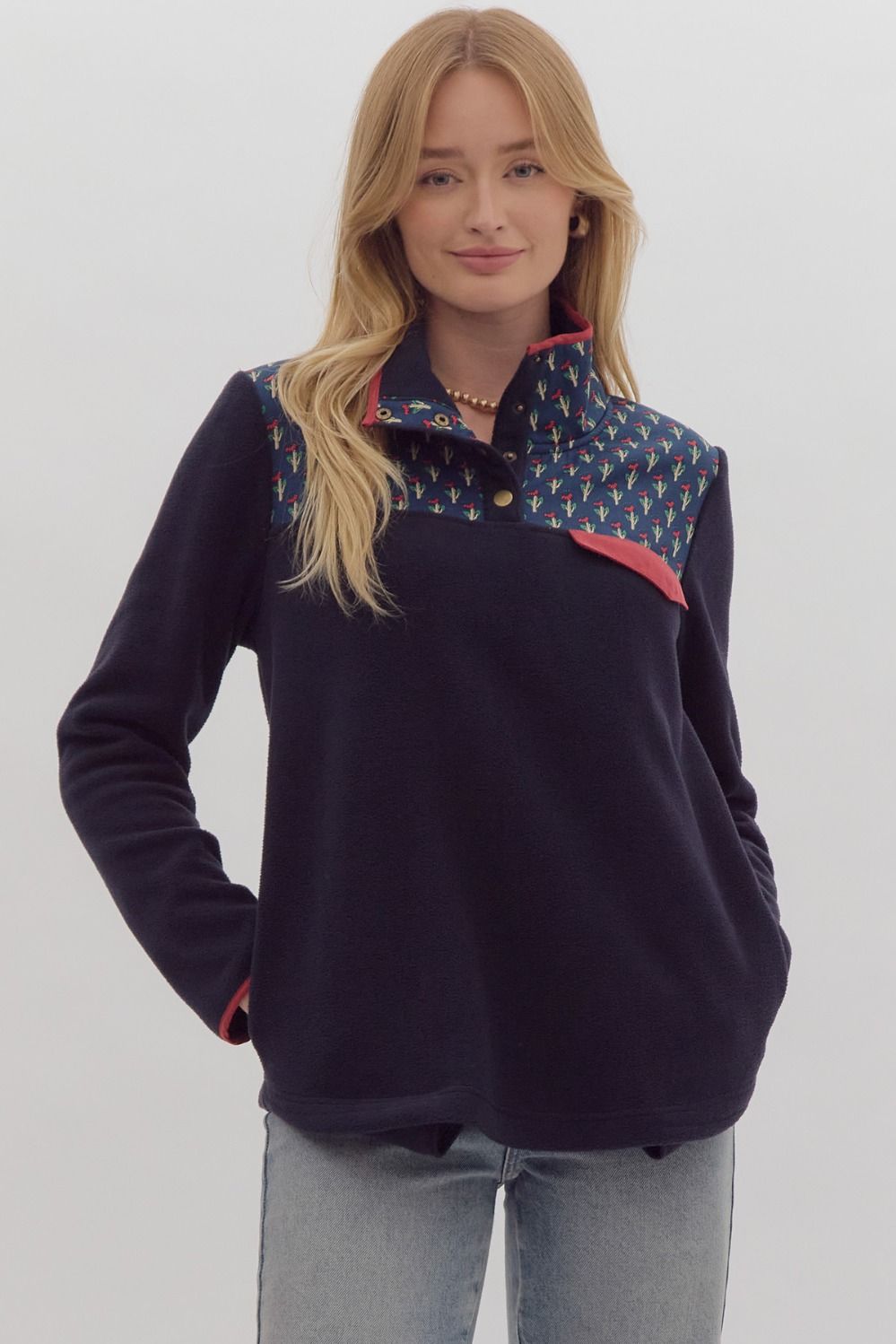 +Solid polar fleece long sleeve collared pullover featuring snap button detail at neckline.