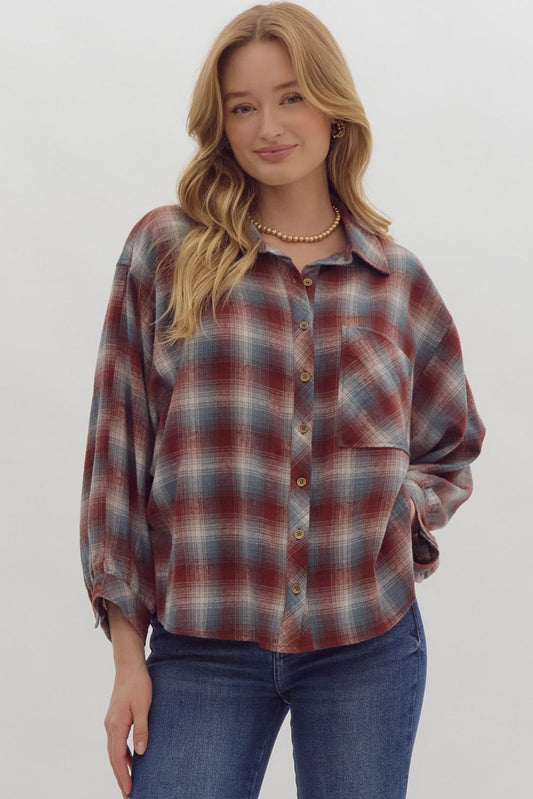 Plaid print 3/4 sleeve button down top featuring pocket detail at bust.