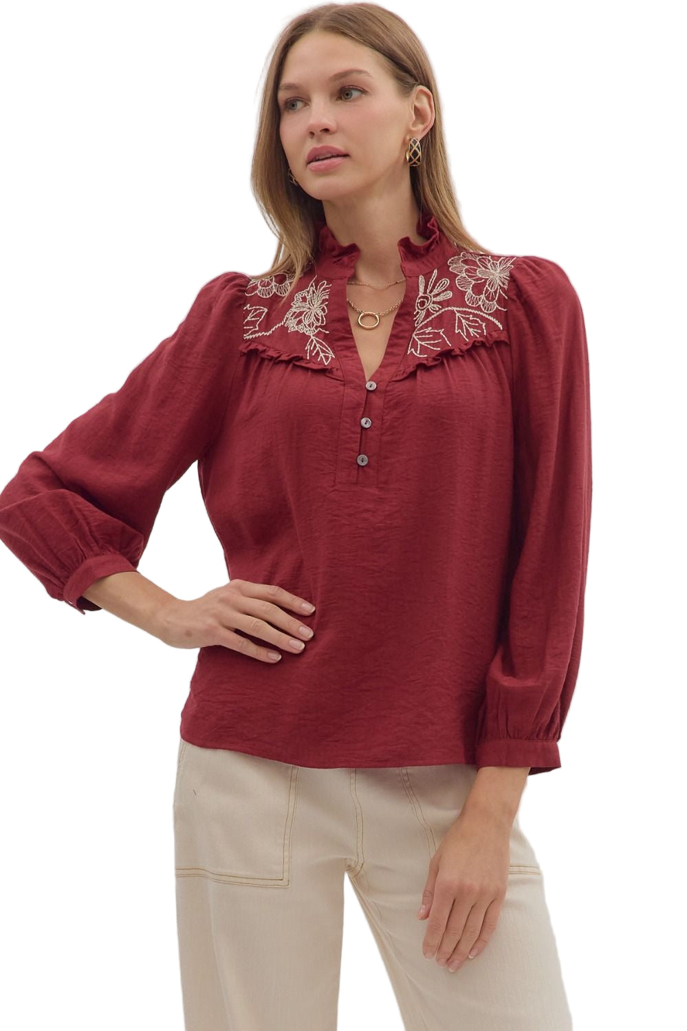 Solid long sleeve top featuring floral embroidery collar with ruffle accent