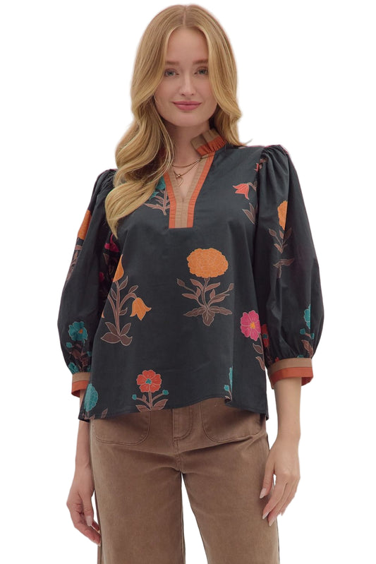 Floral print 3/4 puff sleeve top featuring contrast trim split neck and cuffs